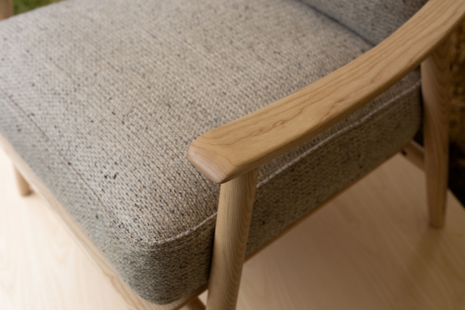 closeup of ercol marino chair arm showing solid wood construction and natural wood grain